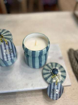 Ceramic candle with striped design and warm cider scent, soy candle