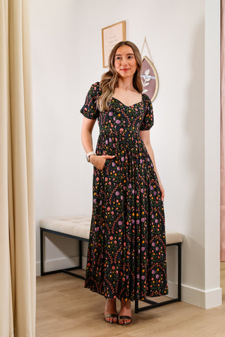 Floral maxi dress, V neckline, black base, puffy sleeves, with pockets, lower back cutout