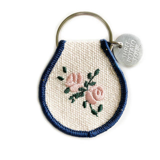 Embroidered keychain with floral design on a white background