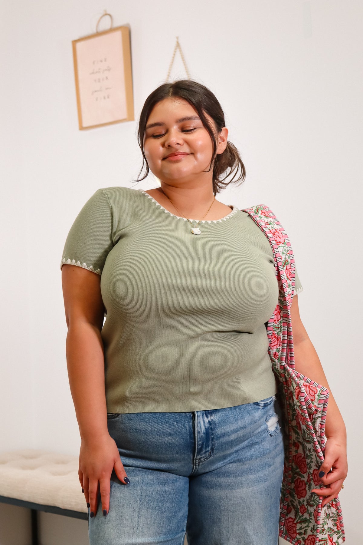 light green, ribbed knit t-shirt with blanket stitch details around the neckline and sleeves