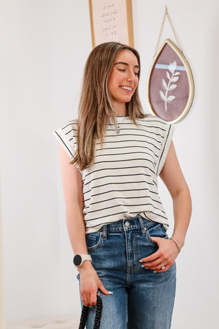 black and white striped top, cuffed blue jeans, black mini purse, everyday outfit