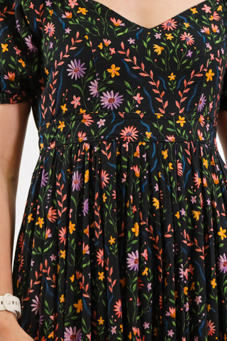 Floral maxi dress, V neckline, black base, puffy sleeves, with pockets, lower back cutout