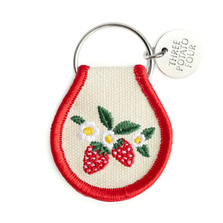 Keychain with embroidered strawberries and daisies on a white background