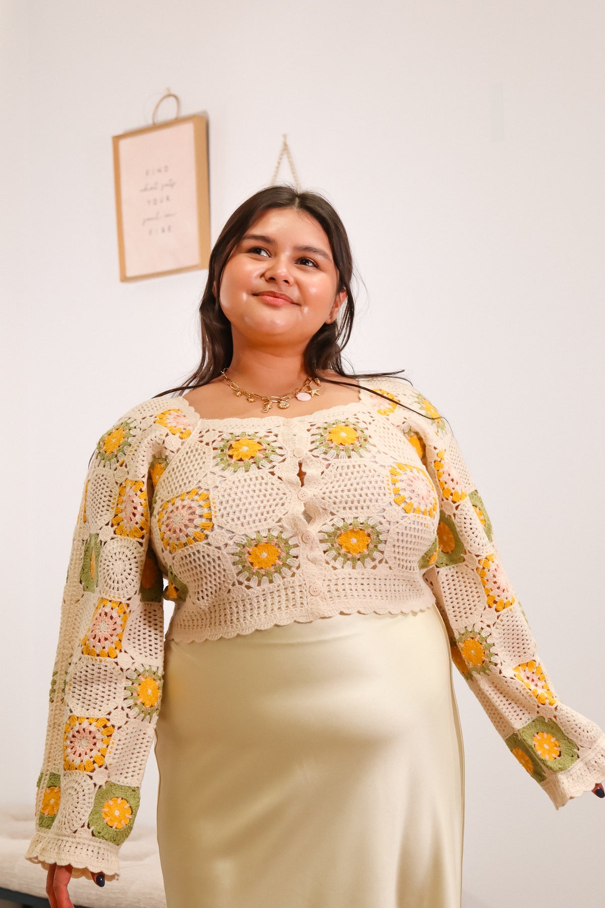 crochet long sleeve top with green, yellow, pink, and beige granny squares