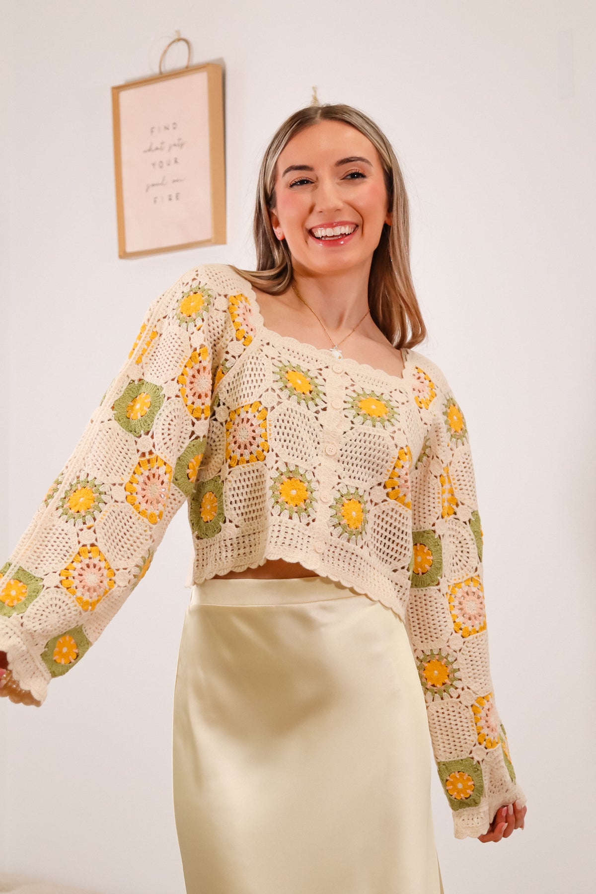 crochet long sleeve top with green, yellow, pink, and beige granny squares