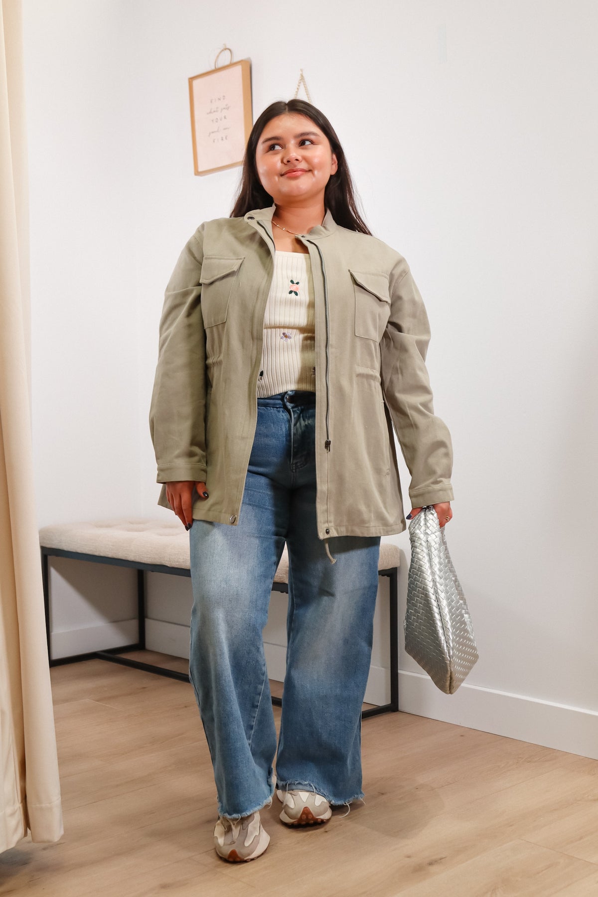 utility women's jacket in olive green with a front zipper, side pockets, and waistline drawstring