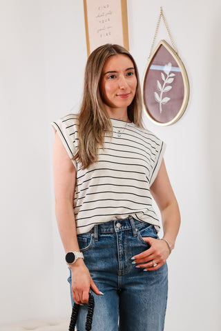 black and white striped top, cuffed blue jeans, black mini purse, everyday outfit