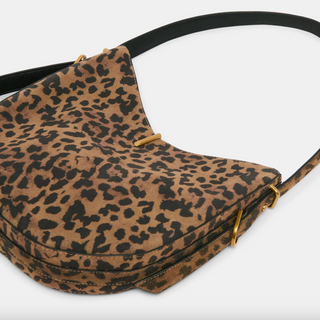 Leopard print handbag with a black strap on a white background
